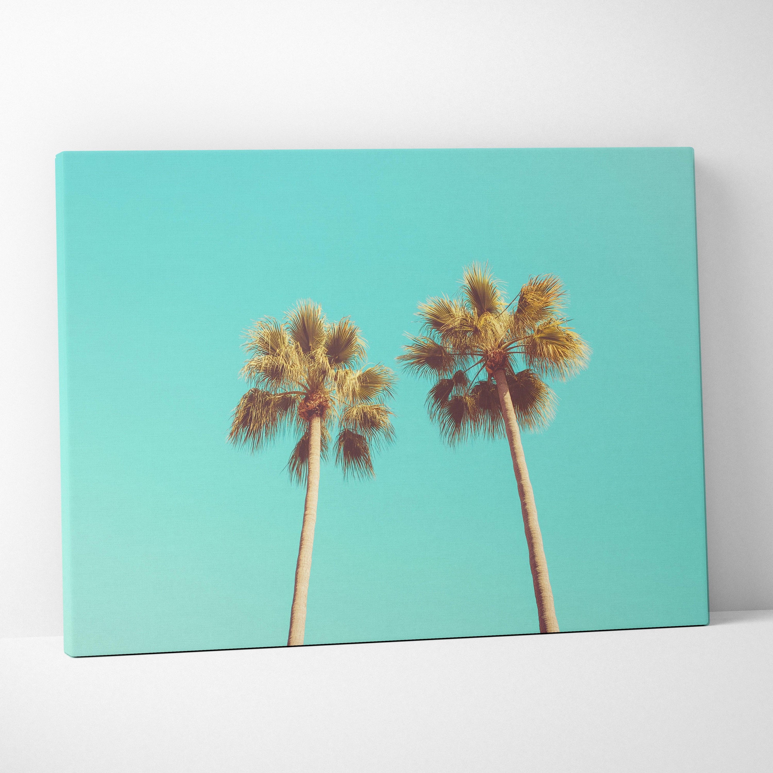Canvas wall art featuring two tall palm trees against a vibrant turquoise sky background.