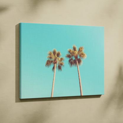 Canvas wall art featuring two tall palm trees against a turquoise sky for tropical decor.