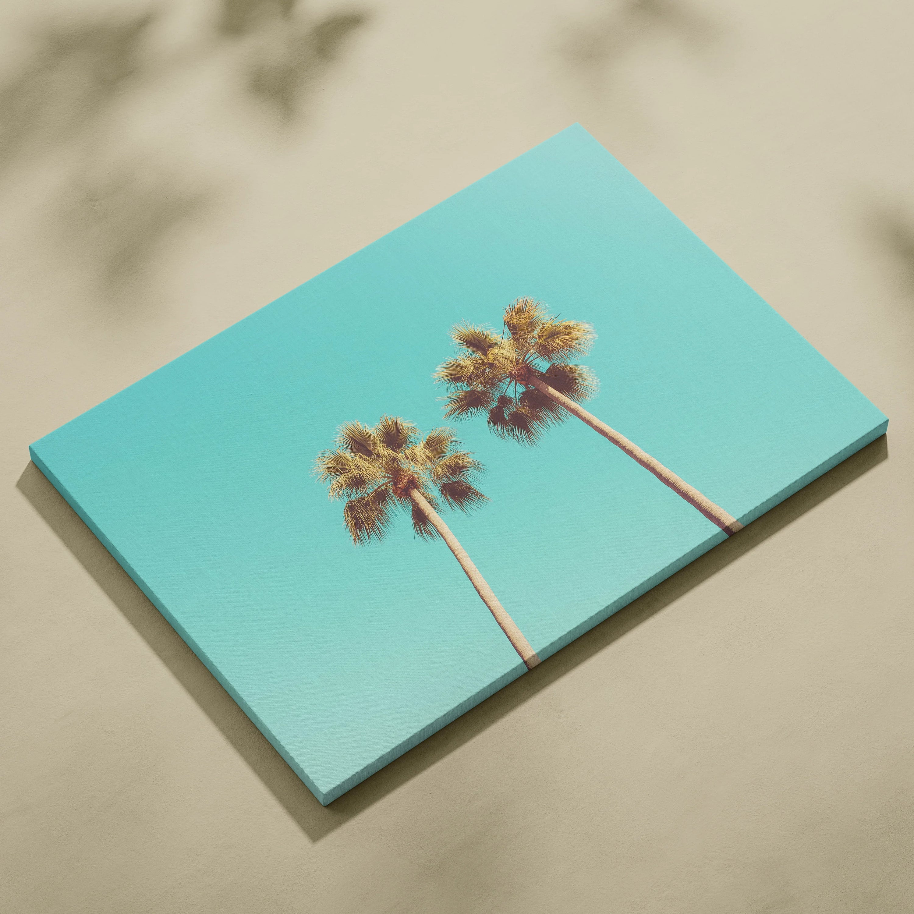 Canvas wall art featuring two tall palm trees against a bright turquoise sky background.