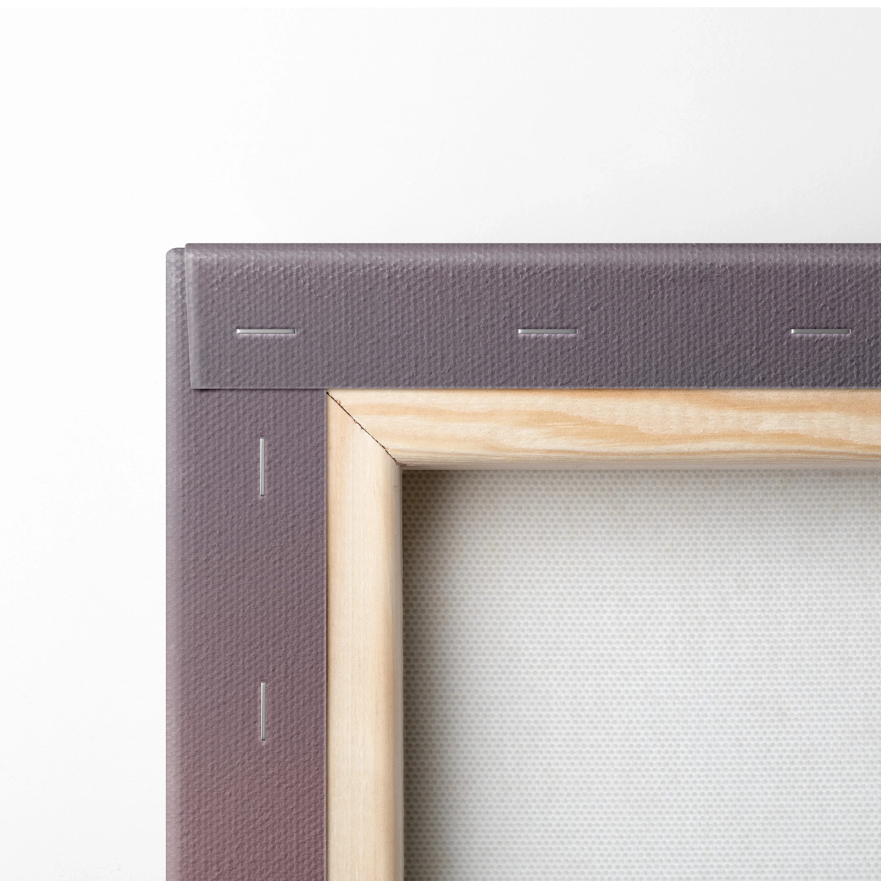 Close-up of wooden frame and purple stretcher bars on the back of canvas wall art decor.