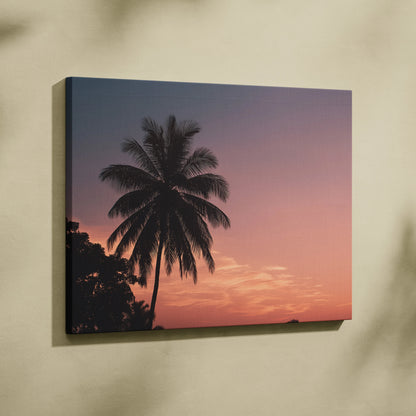 Canvas wall art featuring a tropical palm tree silhouette against a vibrant sunset sky in warm pink and purple tones,.