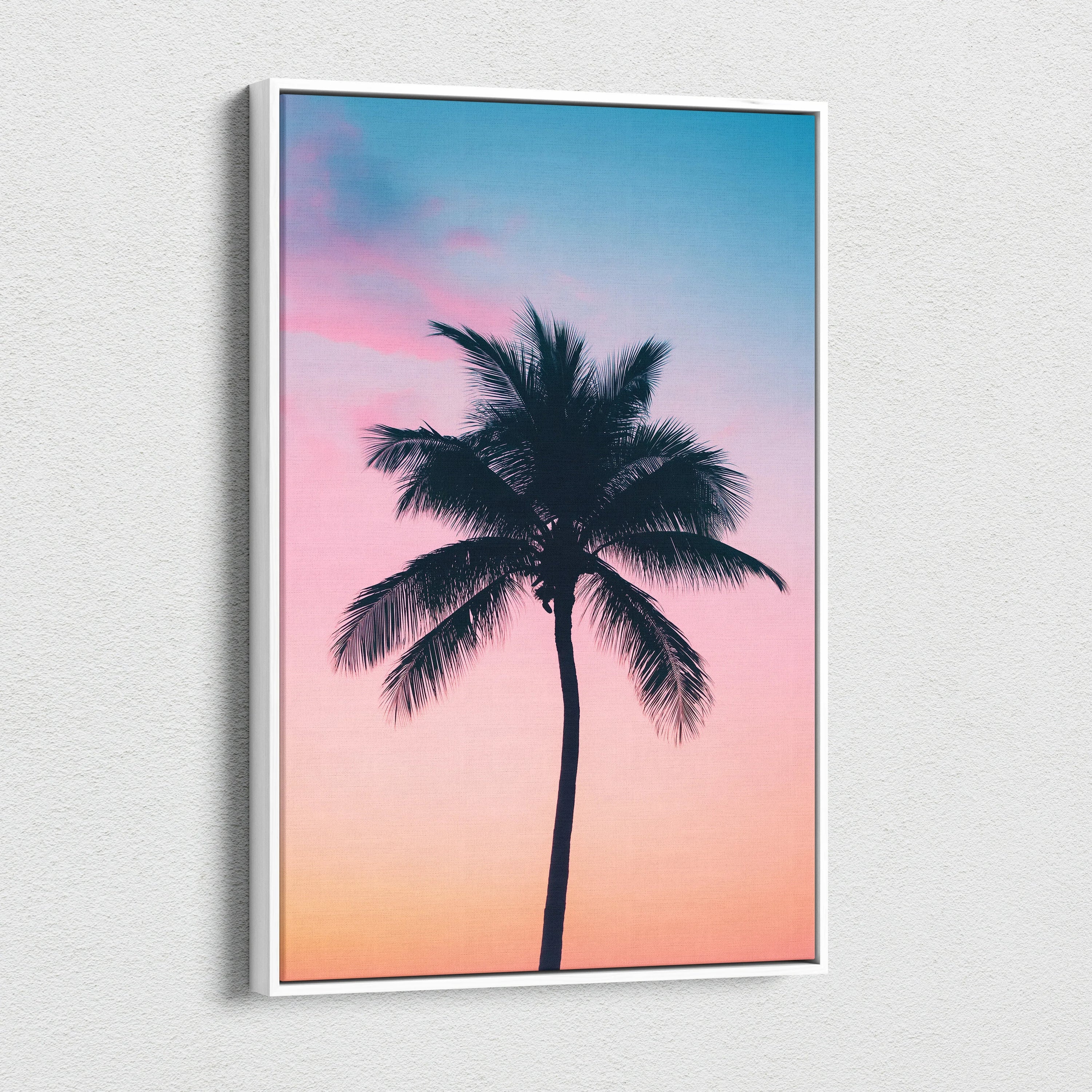 Canvas wall art featuring a tropical palm tree silhouette against a pink and blue sunset sky.