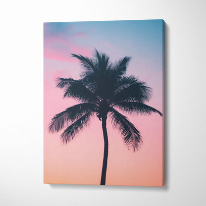Canvas wall art featuring a black palm tree silhouette against a pink and blue sunset sky for tropical decor.