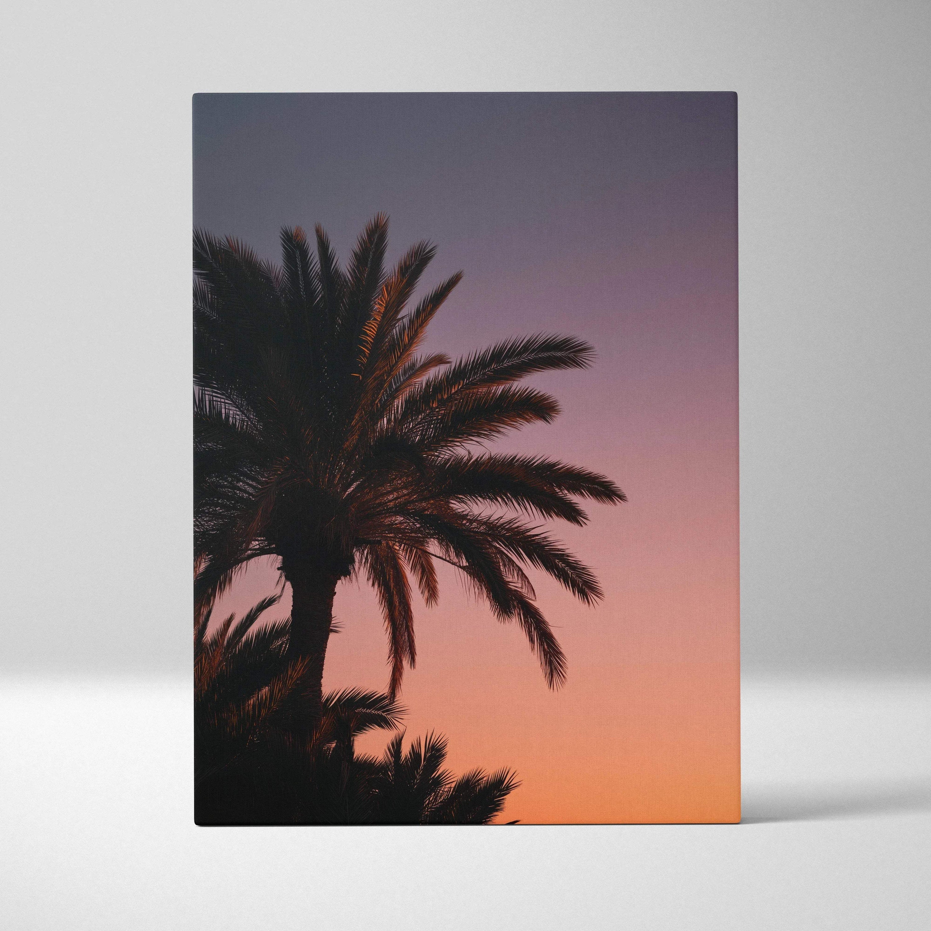 Canvas wall art featuring a palm tree silhouette against a vibrant purple and orange tropical sunset sky.