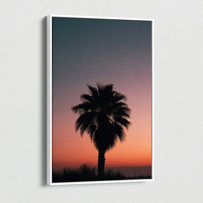 Canvas wall art featuring a black tropical palm tree silhouette against a vibrant orange and purple dusk sky.