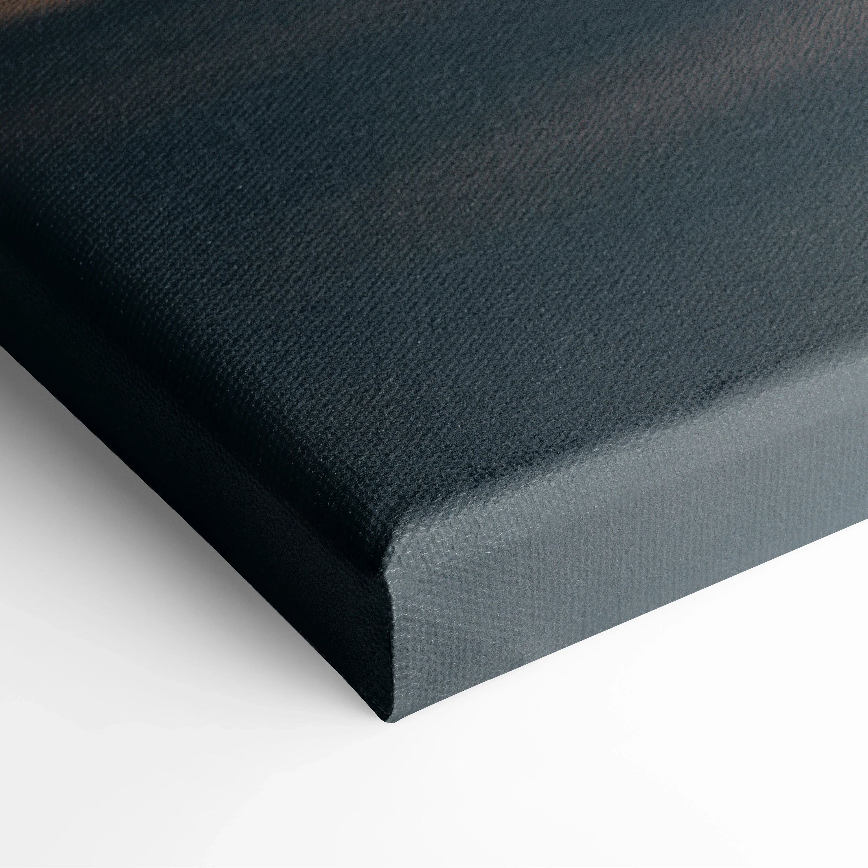 Close-up of black textured canvas corner with stretched fabric for wall art decor.