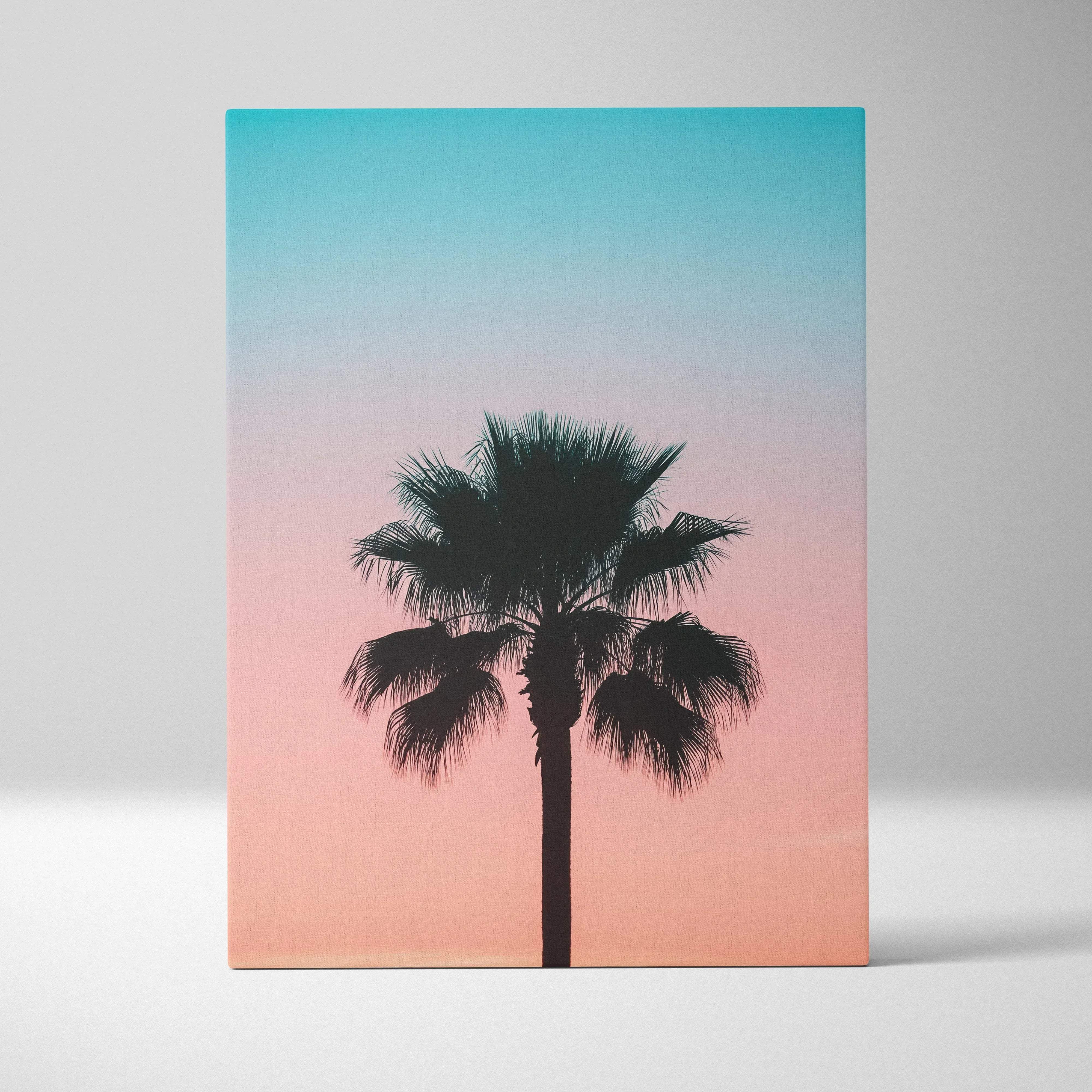 Rectangular canvas wall art featuring a black palm tree silhouette against a teal to soft pink gradient sky for tropical vibes