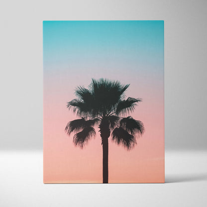 Canvas wall art featuring a black palm tree silhouette against a vivid pink and blue sunset sky decor.