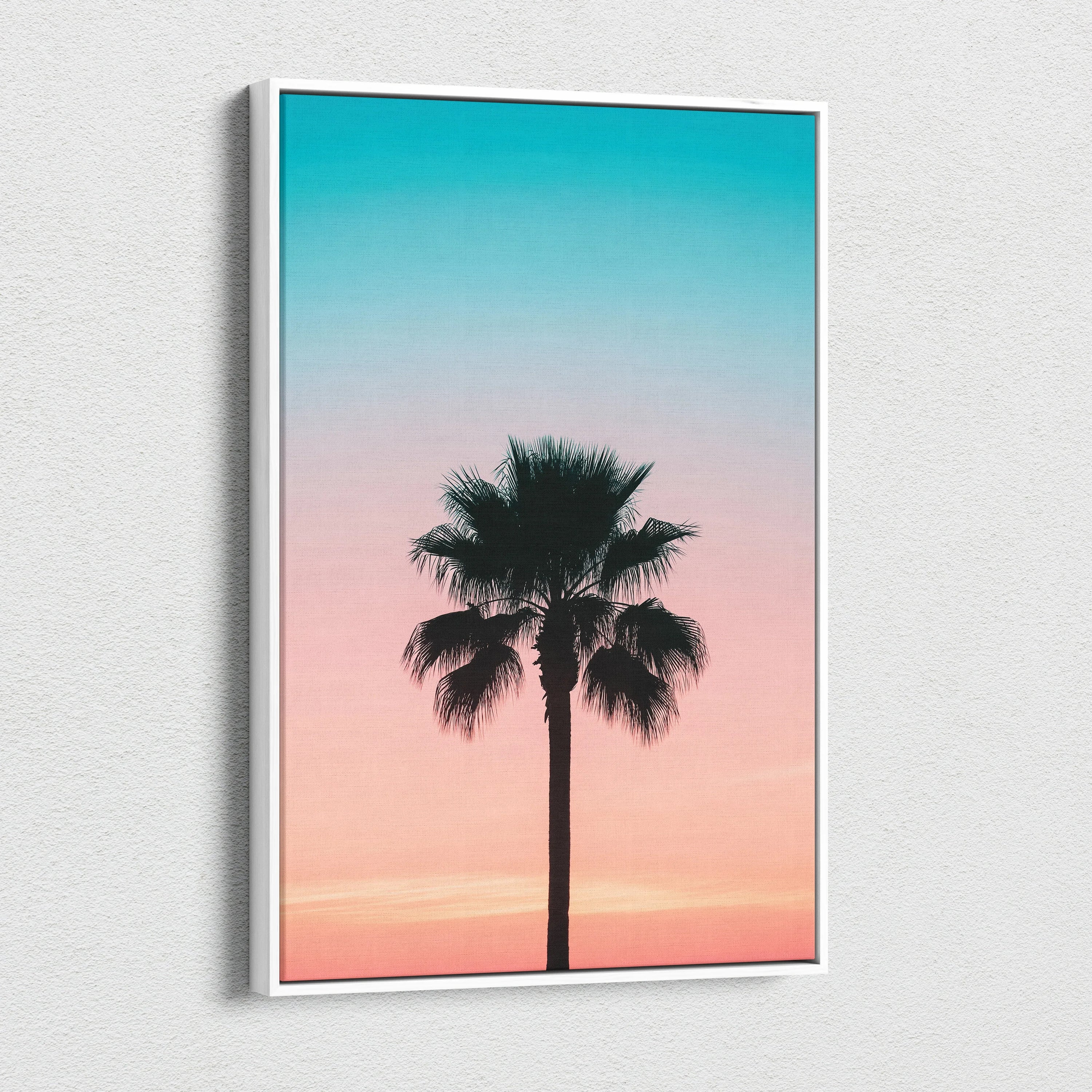 Canvas wall art featuring a black palm tree silhouette against a gradient sunset sky in teal and pink tones.