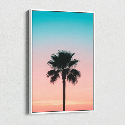 Canvas wall art featuring a black palm tree silhouette against a gradient sunset sky in teal and pink tones.
