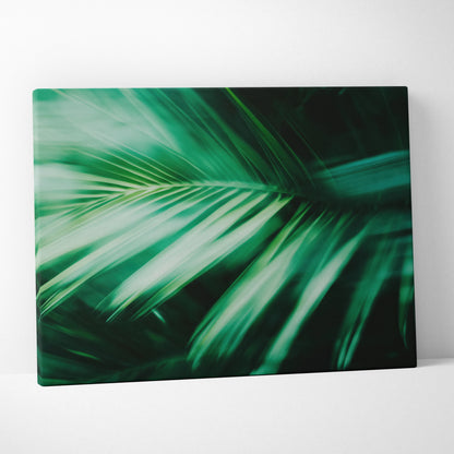 Canvas wall art featuring close-up of vibrant green tropical palm leaves with motion blur effect.