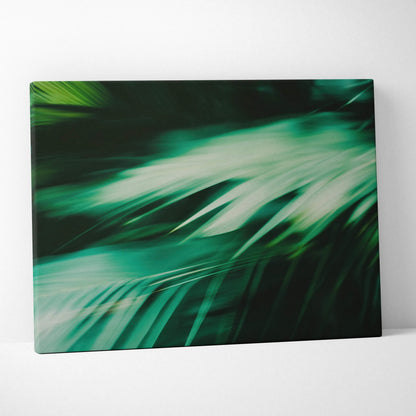 Green tropical leaves close-up digital art on canvas wall decor with dark background.