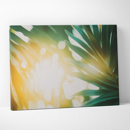 Canvas wall art featuring tropical green leaves with warm golden sun flare highlights creating a serene, natural decor.