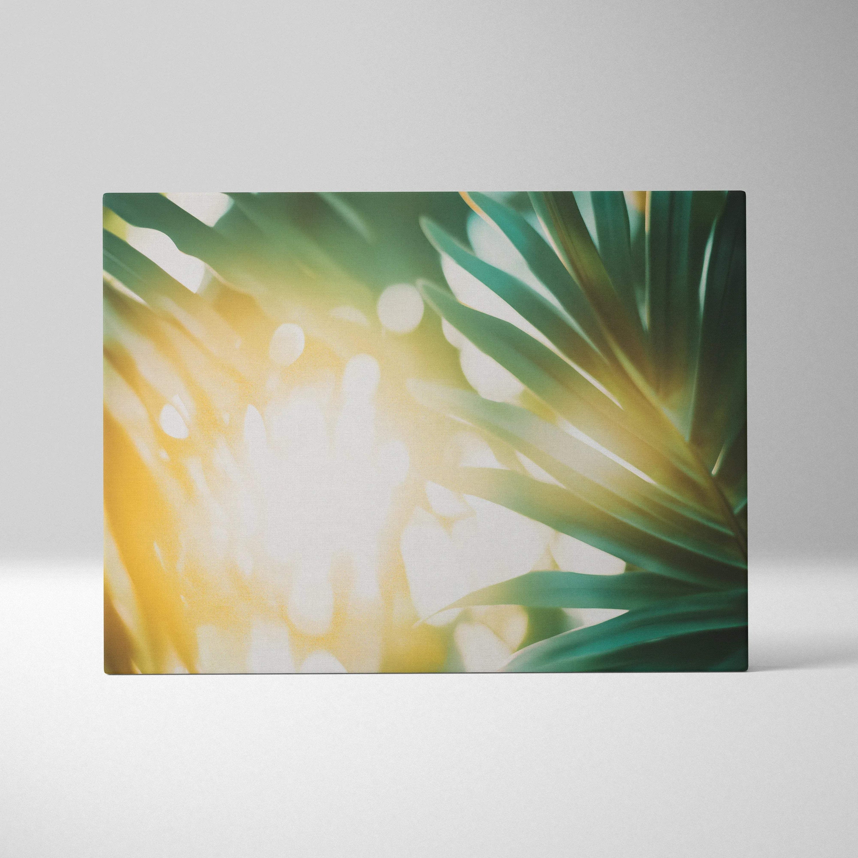 Canvas wall art featuring green tropical leaves with warm golden sun flare and soft light effects.