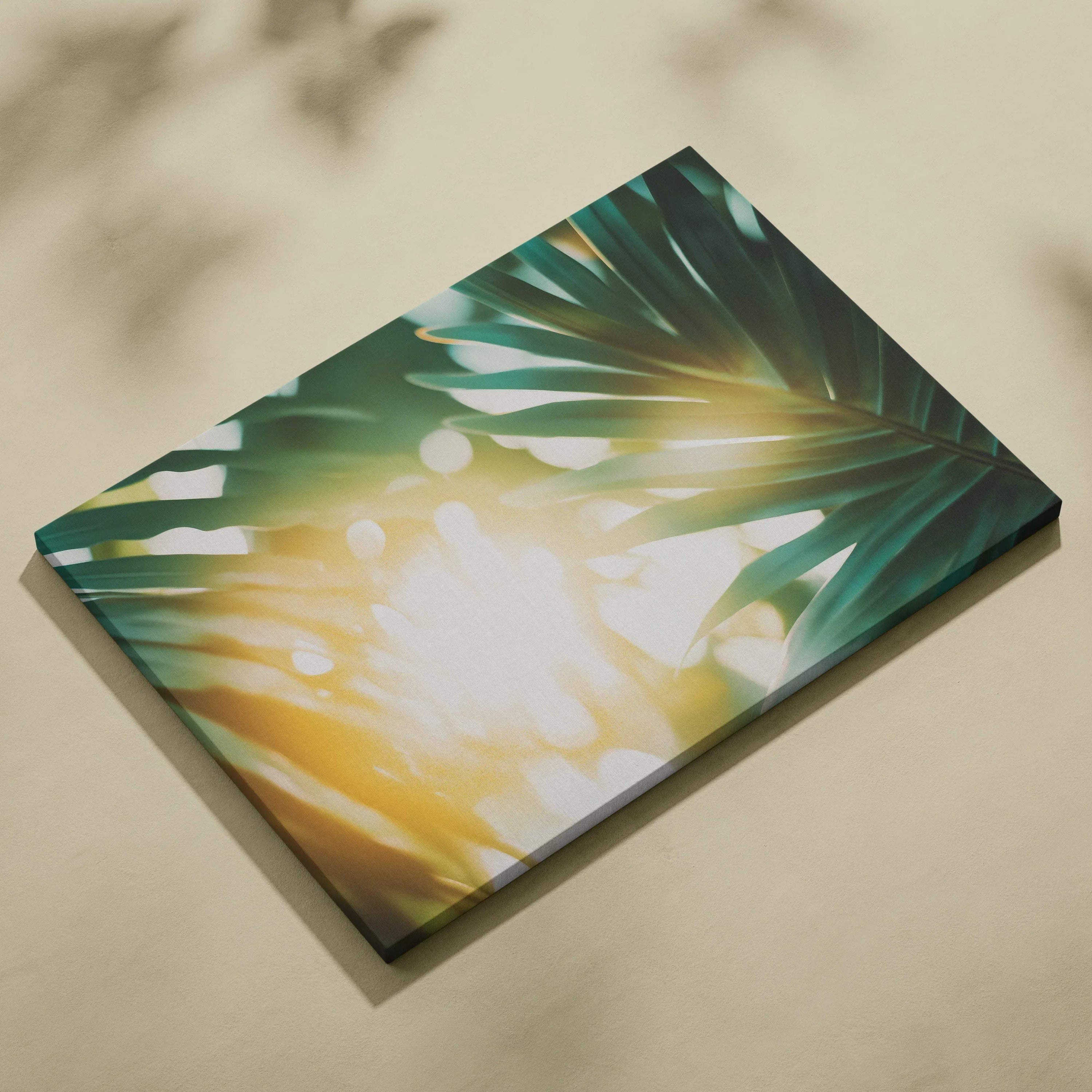 Canvas wall art featuring tropical green leaves with warm golden sun flare accents.