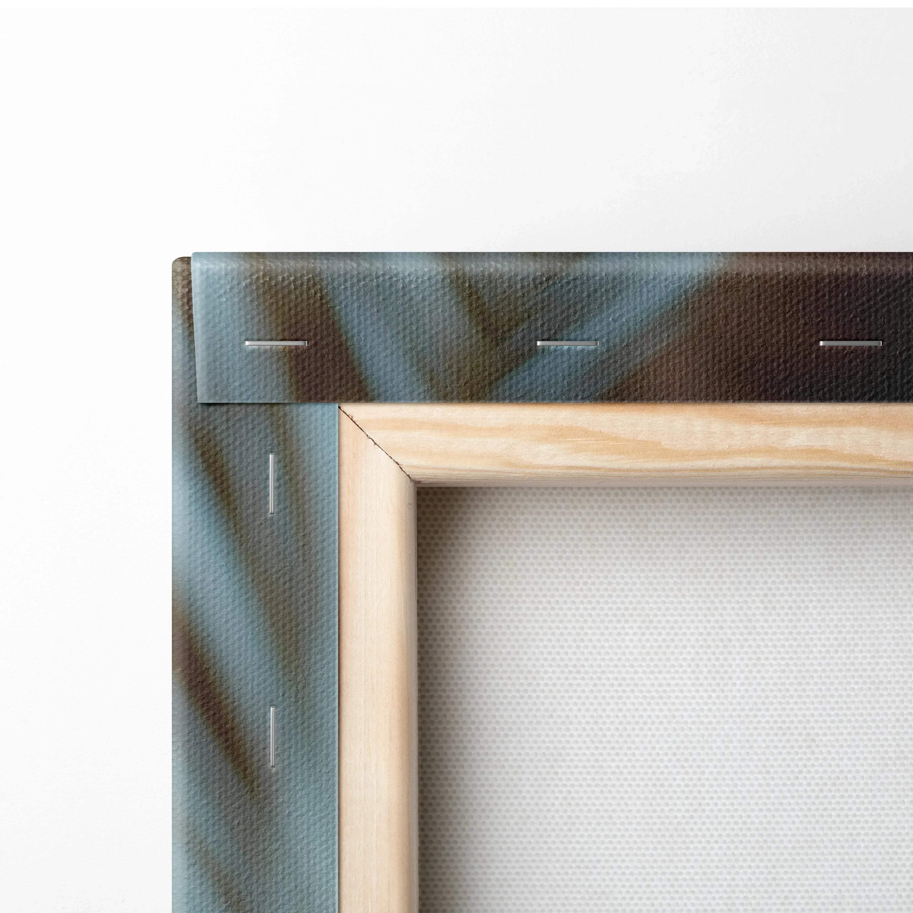 Close-up of wooden frame with canvas stretched and stapled, showing part of tropical beach print.