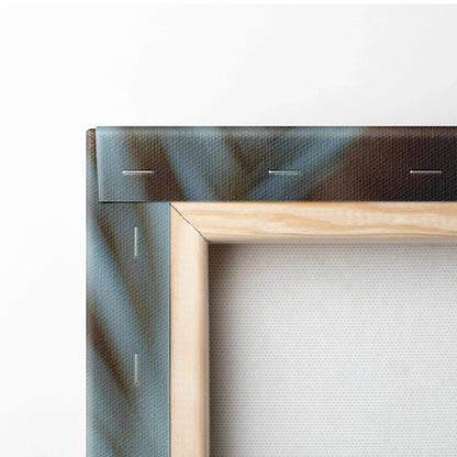 Close-up of wooden frame with canvas stretched and stapled, showing part of tropical beach print.