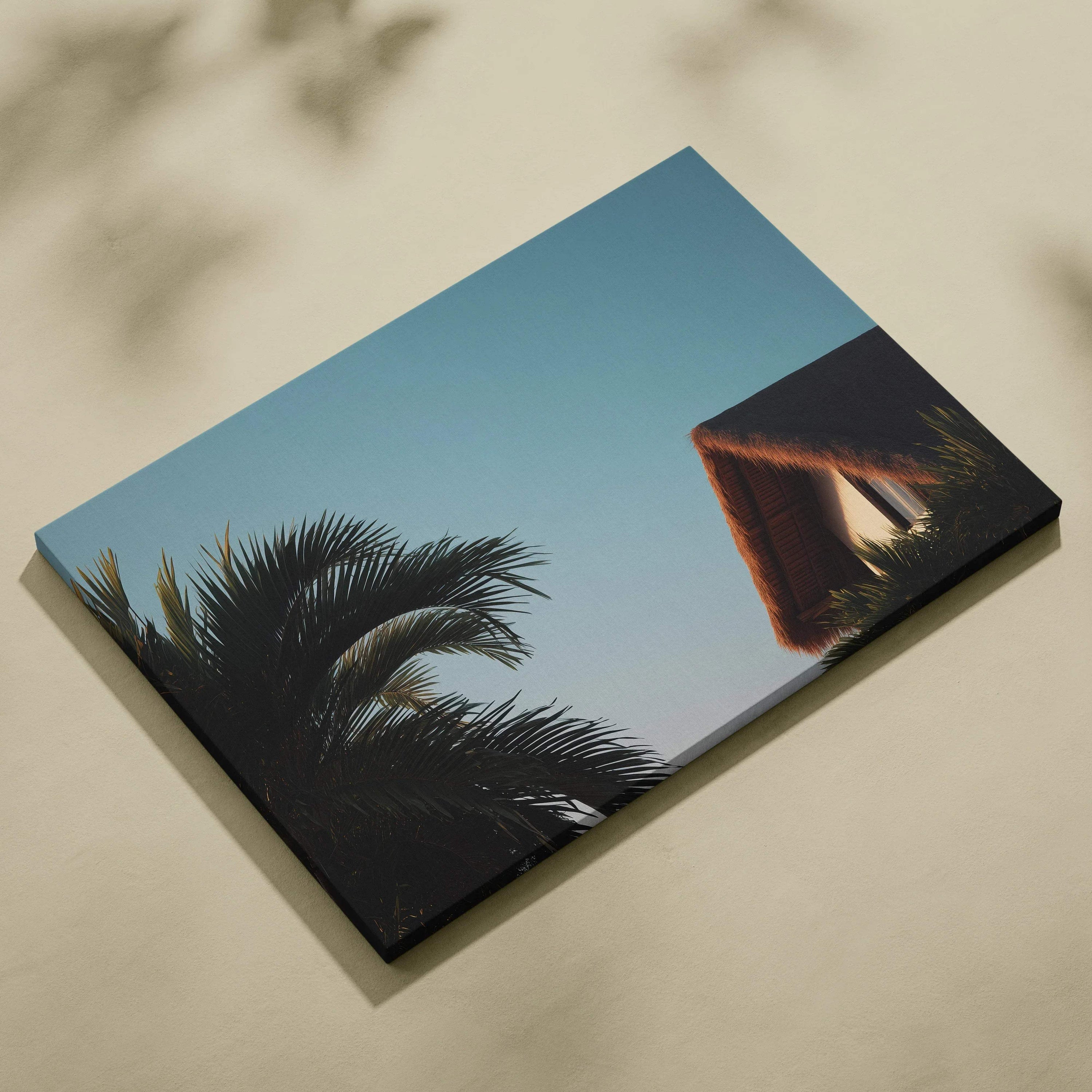Canvas wall art featuring digital tropical scene with palm trees and a thatched roof house against clear blue sky.