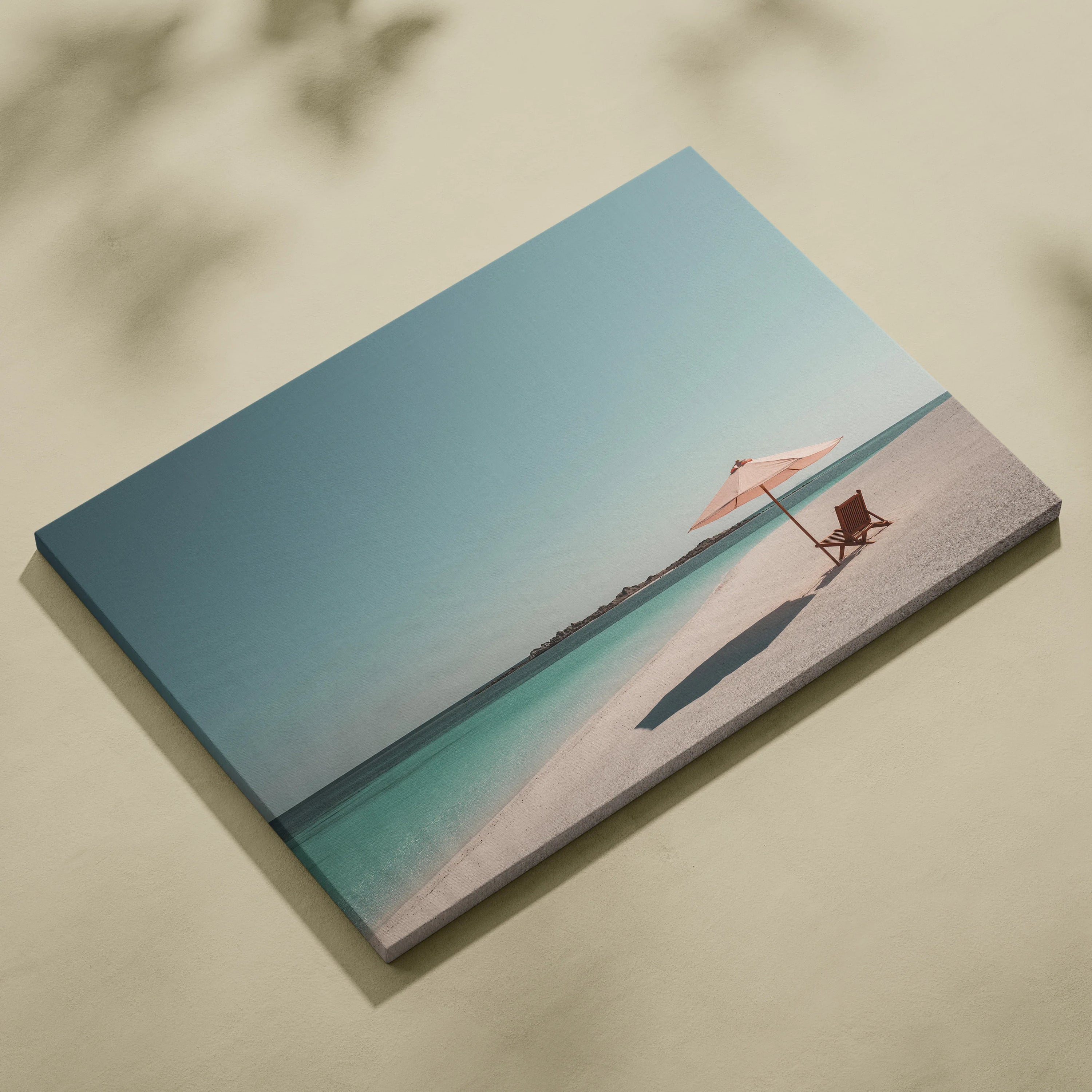 Tropical beach canvas wall art with wooden chair and pink umbrella on white sand.