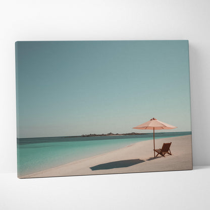 Canvas wall art featuring a serene tropical beach with turquoise water, white sand, a wooden chair, and a pink umbrella.