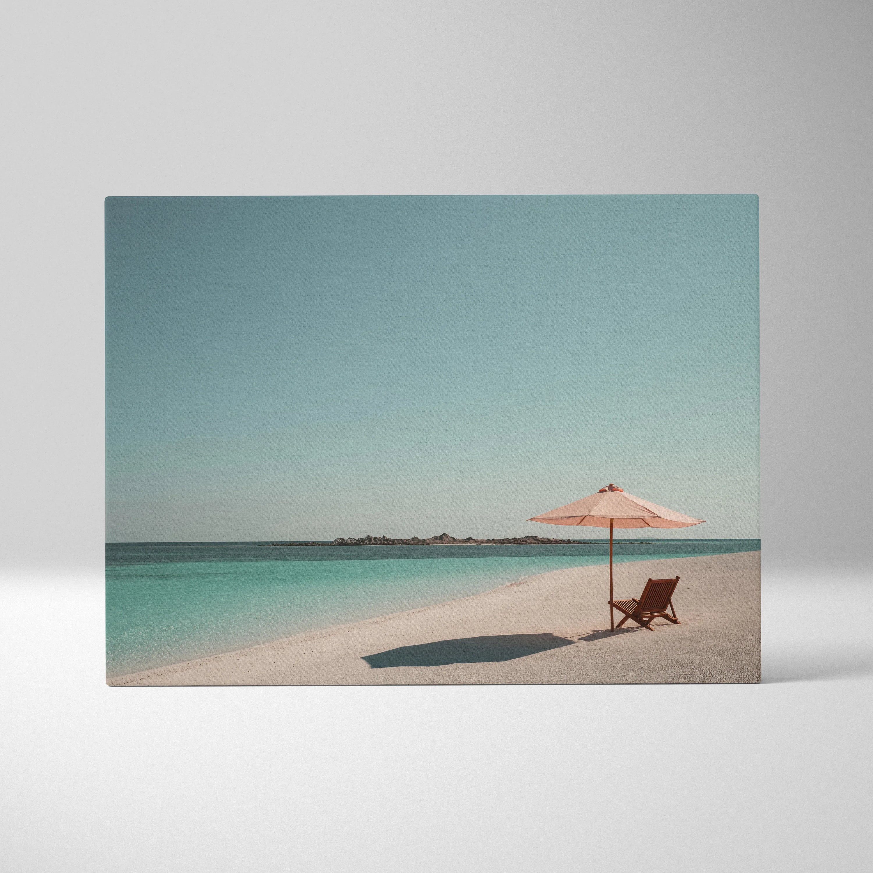 Canvas wall art featuring a tropical beach with a wooden chair and pink umbrella on white sand under a clear blue sky.