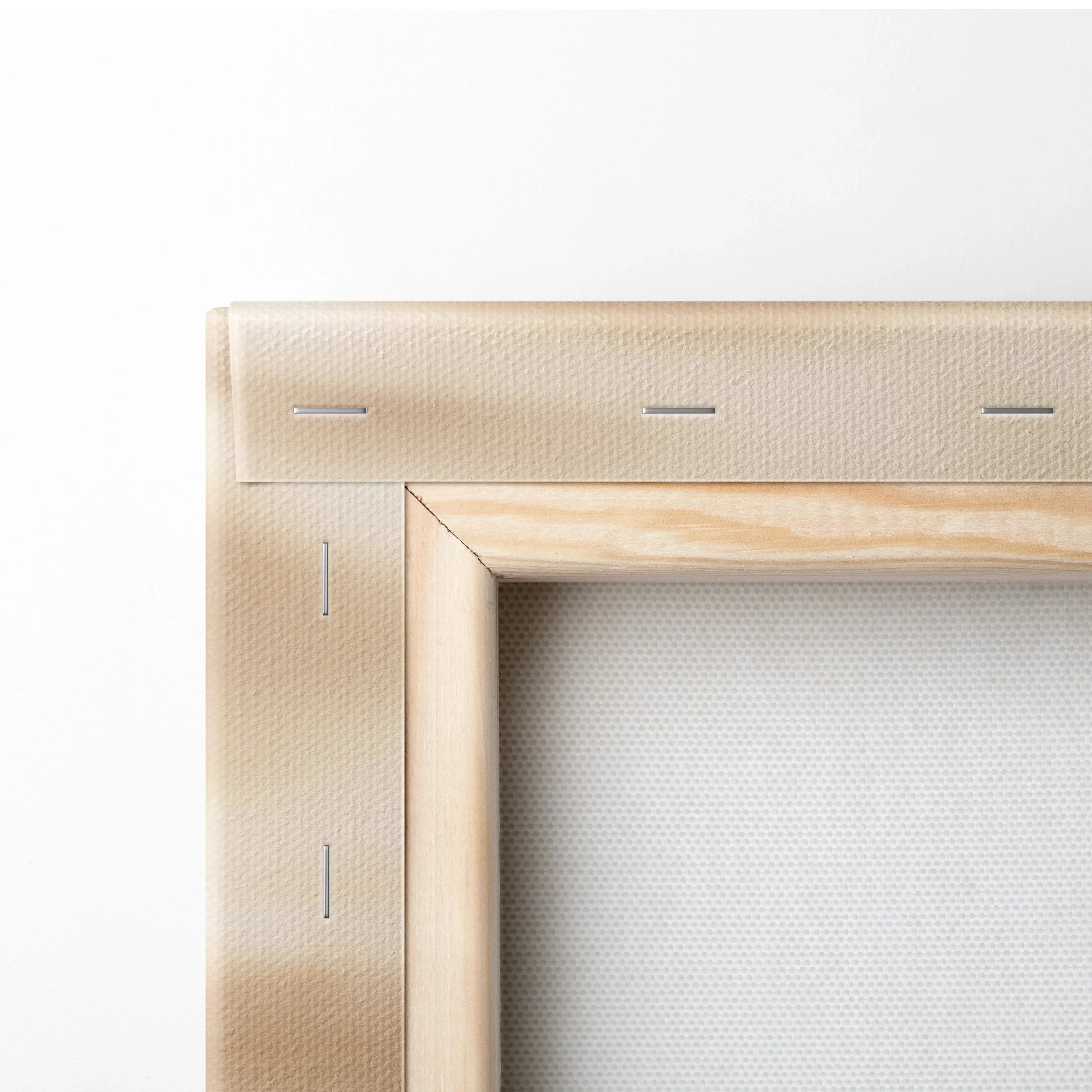 Natural wood frame corner of stretched canvas wall art with sand texture digital print.