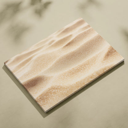Canvas wall art featuring a close-up digital print of textured beach sand in warm beige tones.