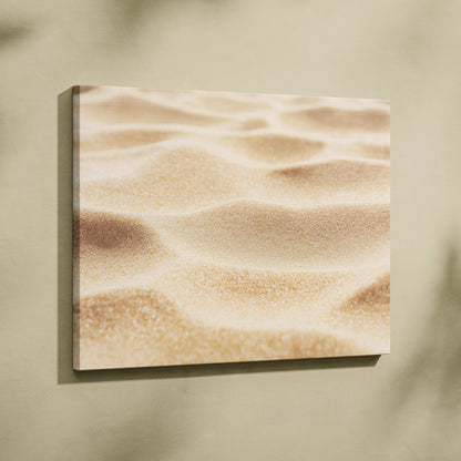 Canvas wall art featuring a close-up digital print of textured beach sand in warm beige tones.