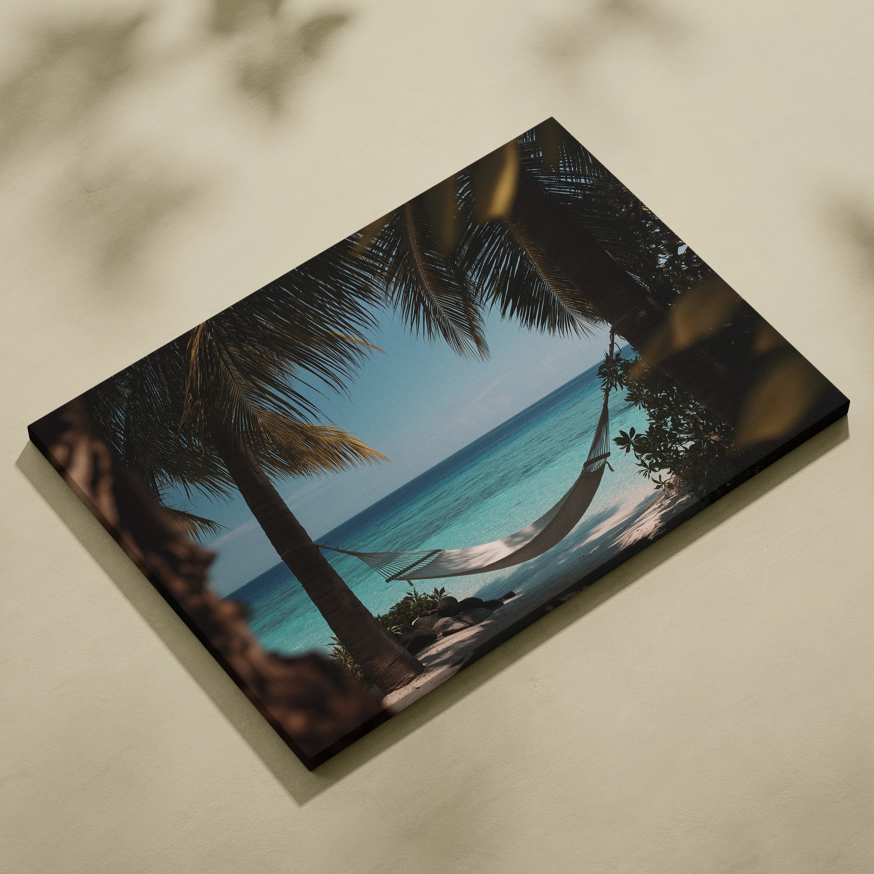 Canvas wall art featuring a tropical beach scene with a white hammock between palm trees and blue ocean background.