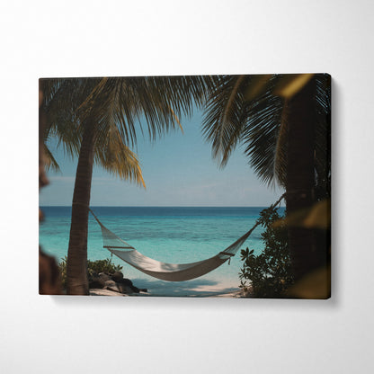 Digital art canvas wall art featuring a tropical beach hammock between palm trees with ocean view decor.