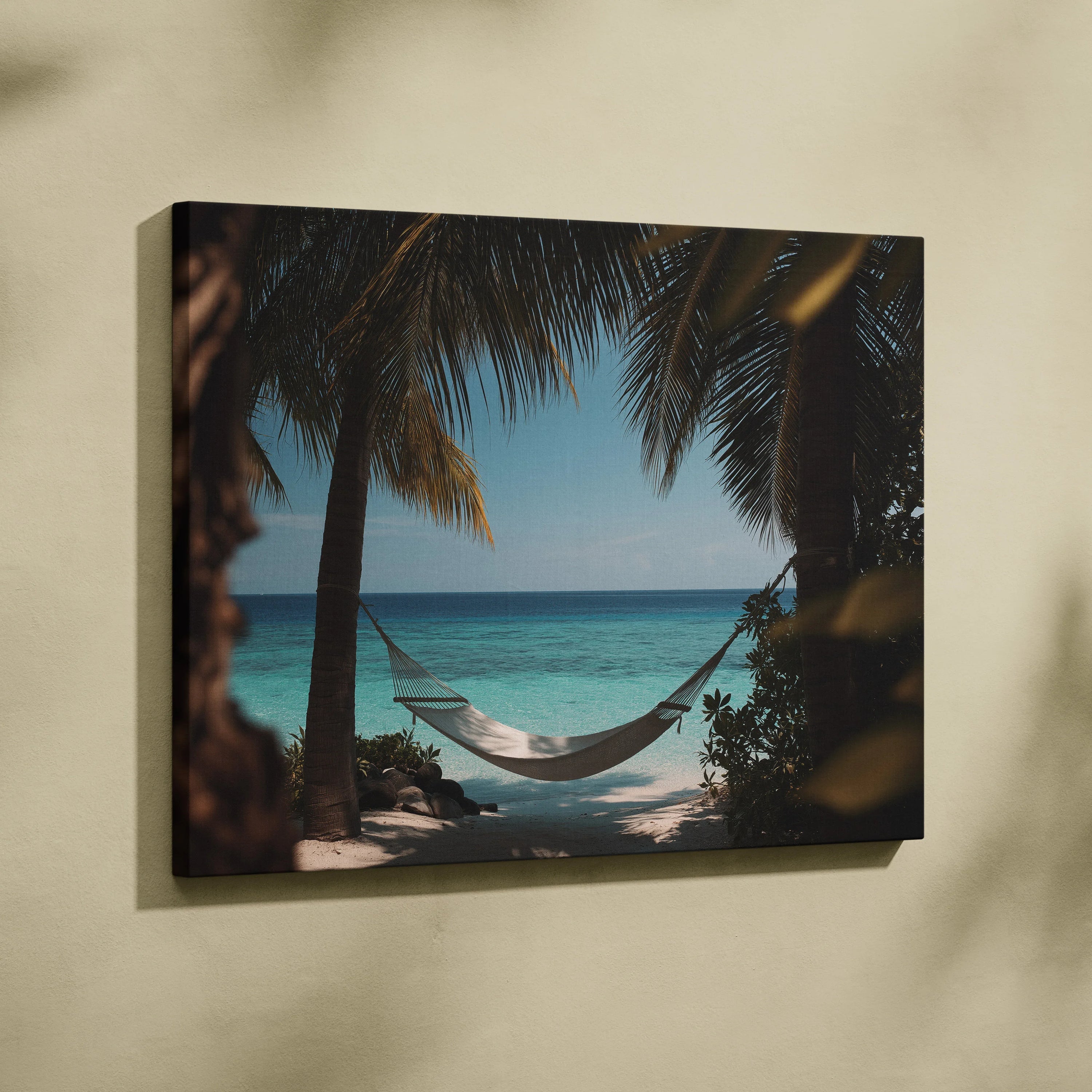Canvas wall art depicting a white hammock hanging between palm trees overlooking turquoise ocean under clear blue sky.