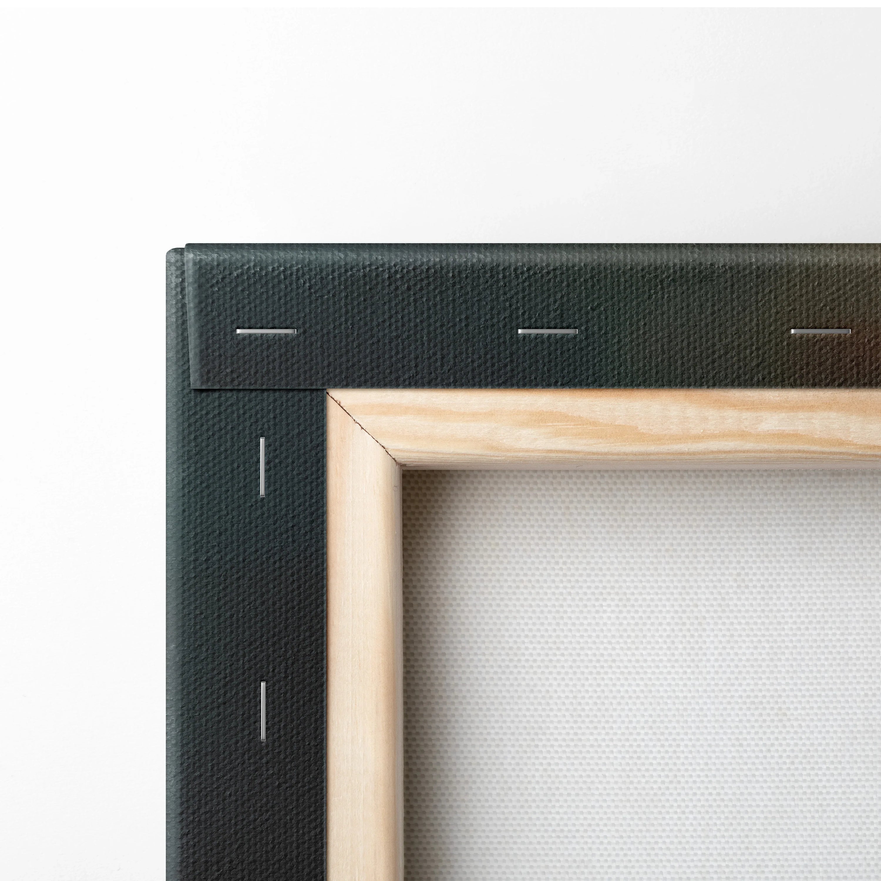 Close-up of wooden stretcher frame with black canvas wrapped and stapled on the back for wall art decor.
