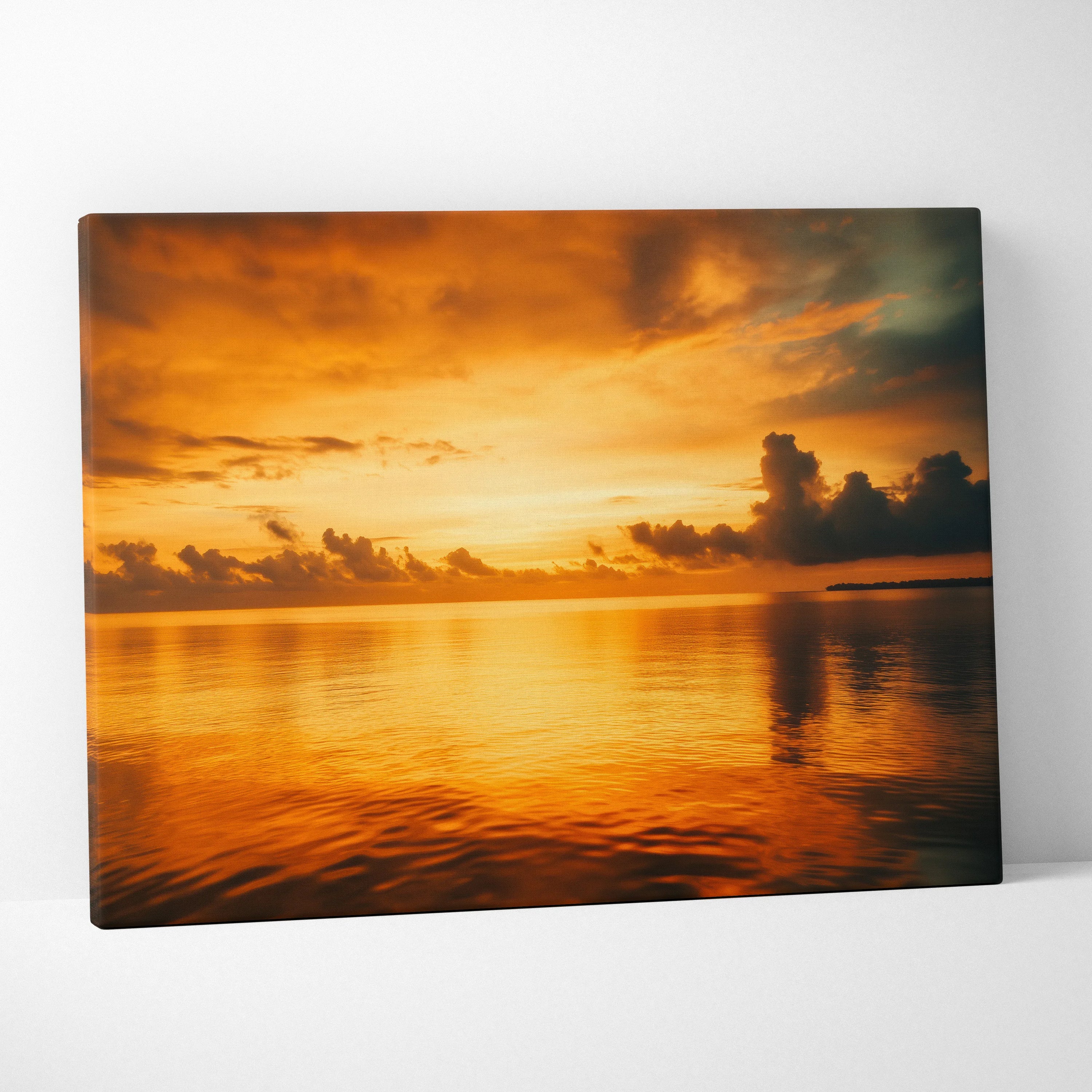 Canvas wall art featuring a vibrant orange and yellow ocean sunset with clouds over calm reflective water.