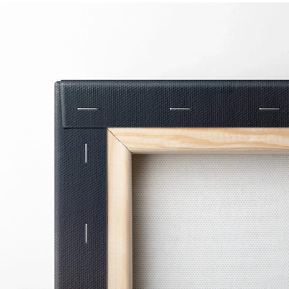 Close-up of wooden stretcher frame with black canvas edges and visible staple fastenings for wall art decor.