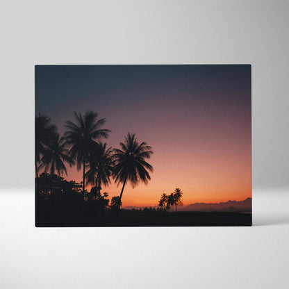 Canvas wall art featuring a digital tropical sunset with black silhouette palm trees against a gradient dusk sky.