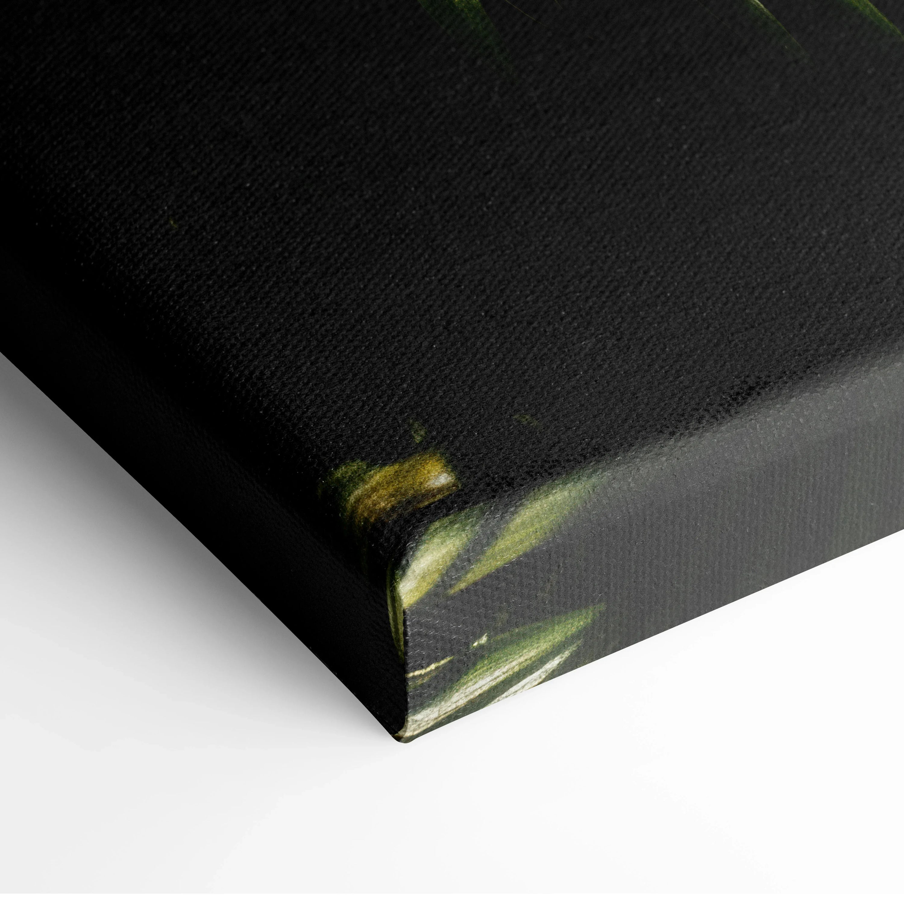 Corner detail of black canvas with lush green tropical palm leaf print for wall art decor.