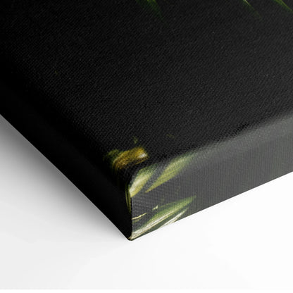 Corner detail of black canvas with lush green tropical palm leaf print for wall art decor.