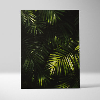 Vertical canvas wall art featuring lush green tropical palm leaves on a dark background decor.