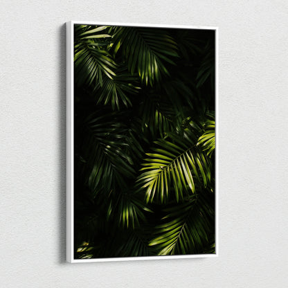 Canvas wall art featuring lush green tropical palm leaves with contrasting dark shadows.