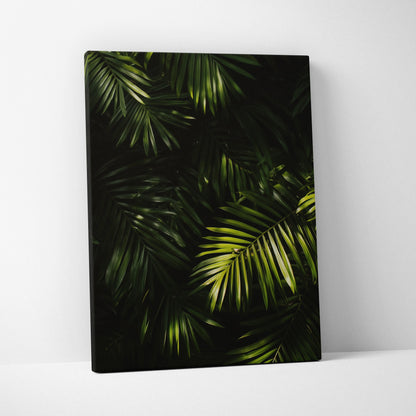Canvas wall art featuring lush green tropical palm leaves with dark, moody background decor.