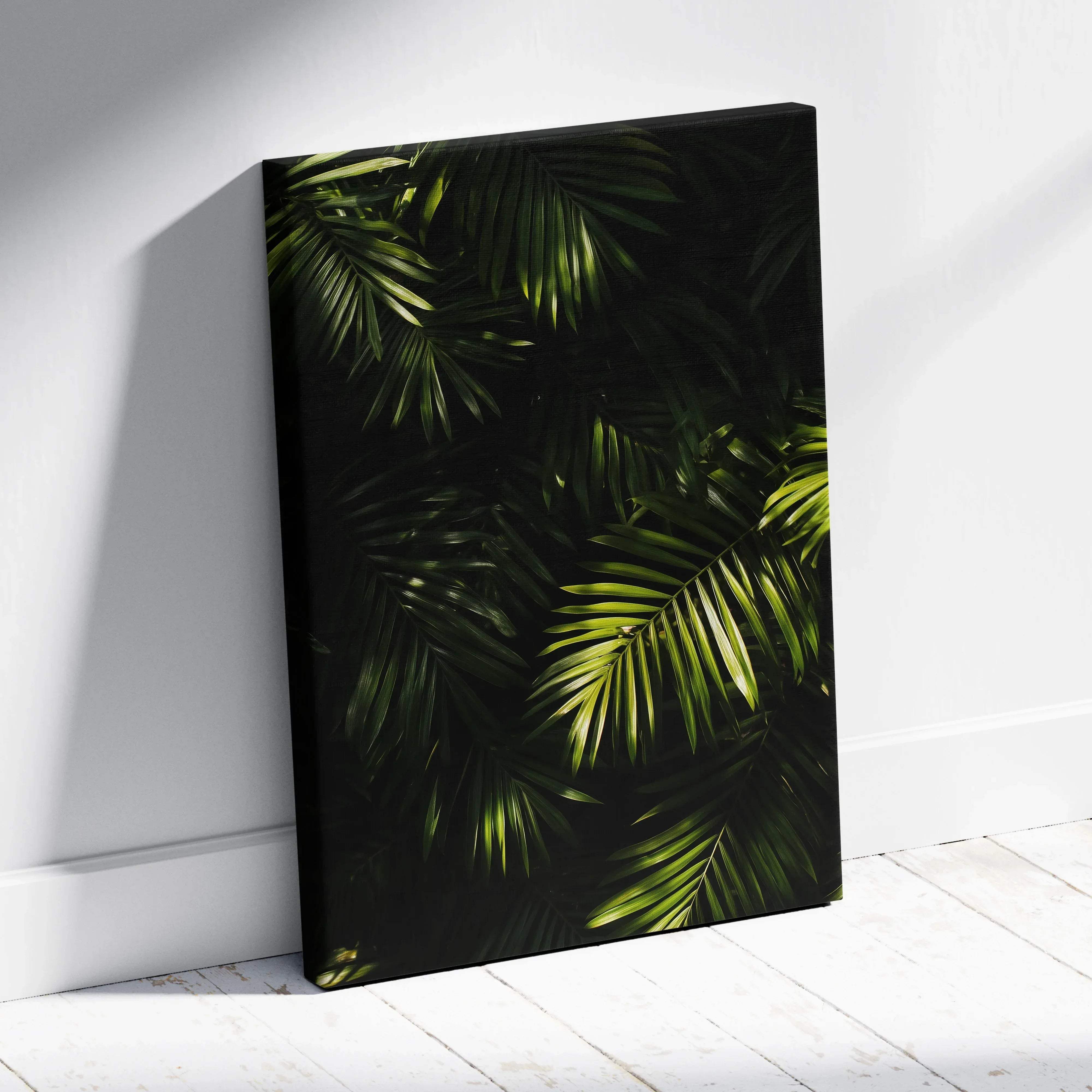 A black-framed canvas print featuring vibrant green tropical palm leaves for lush jungle wall decor
