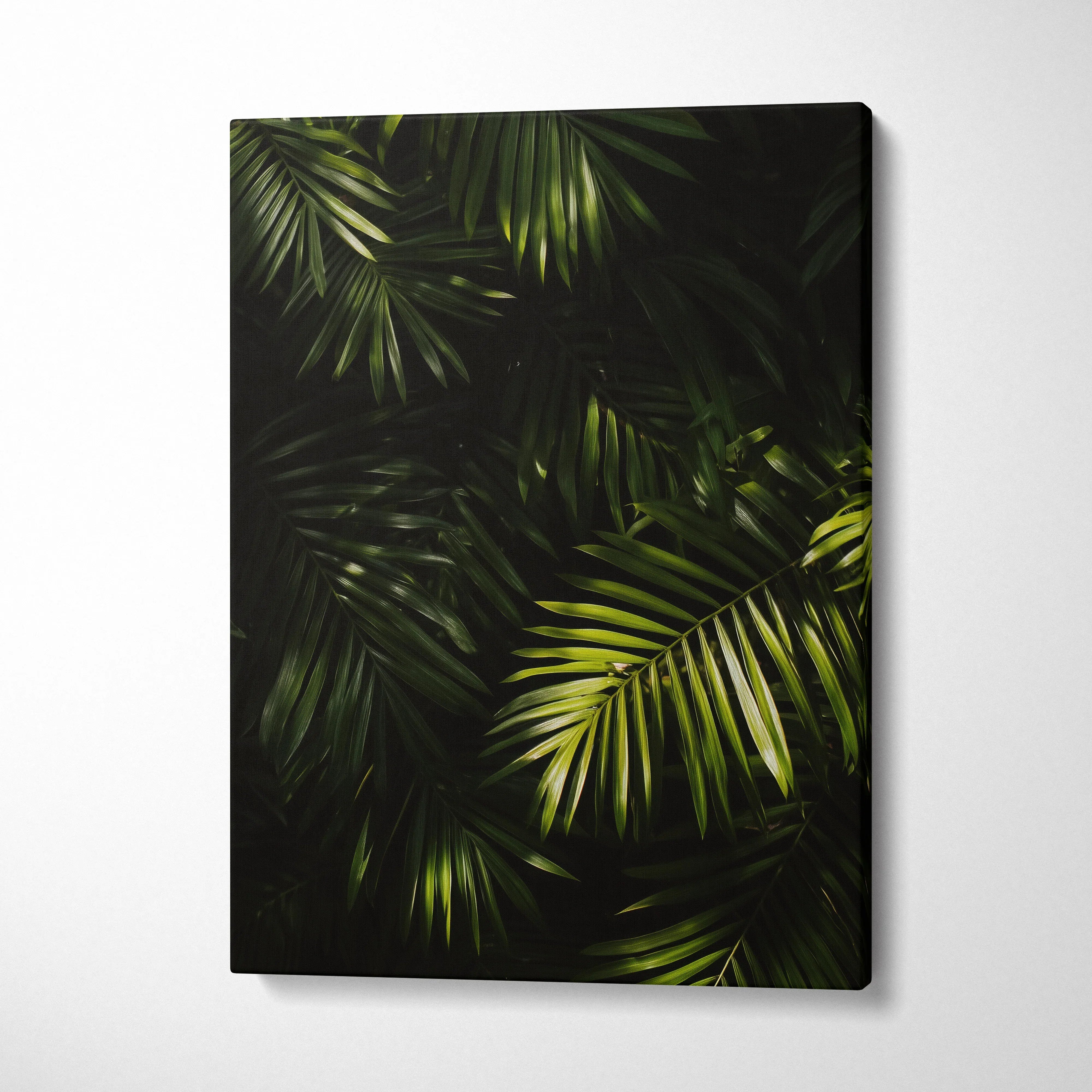 Lush green tropical palm leaves on black background canvas wall art decor.
