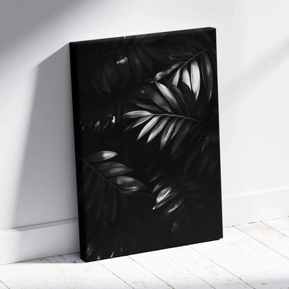 Black and white digital canvas art print of overlapping tropical palm leaves with a matte finish.