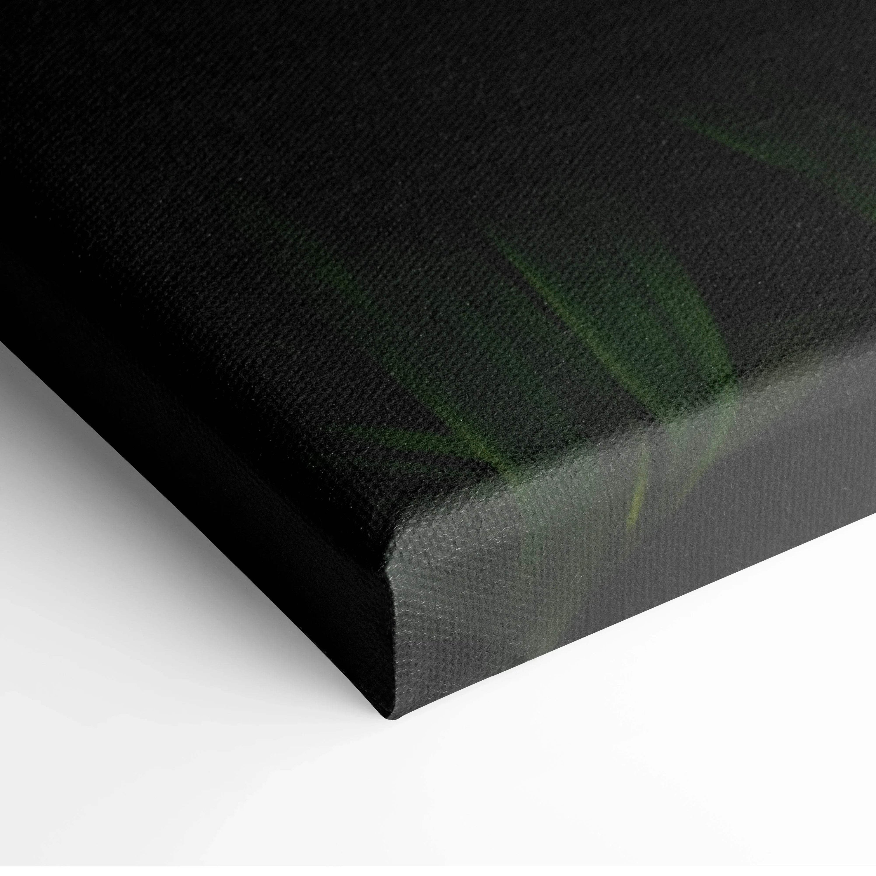 Close-up of black canvas wall art with subtle green tropical leaf details and textured surface.