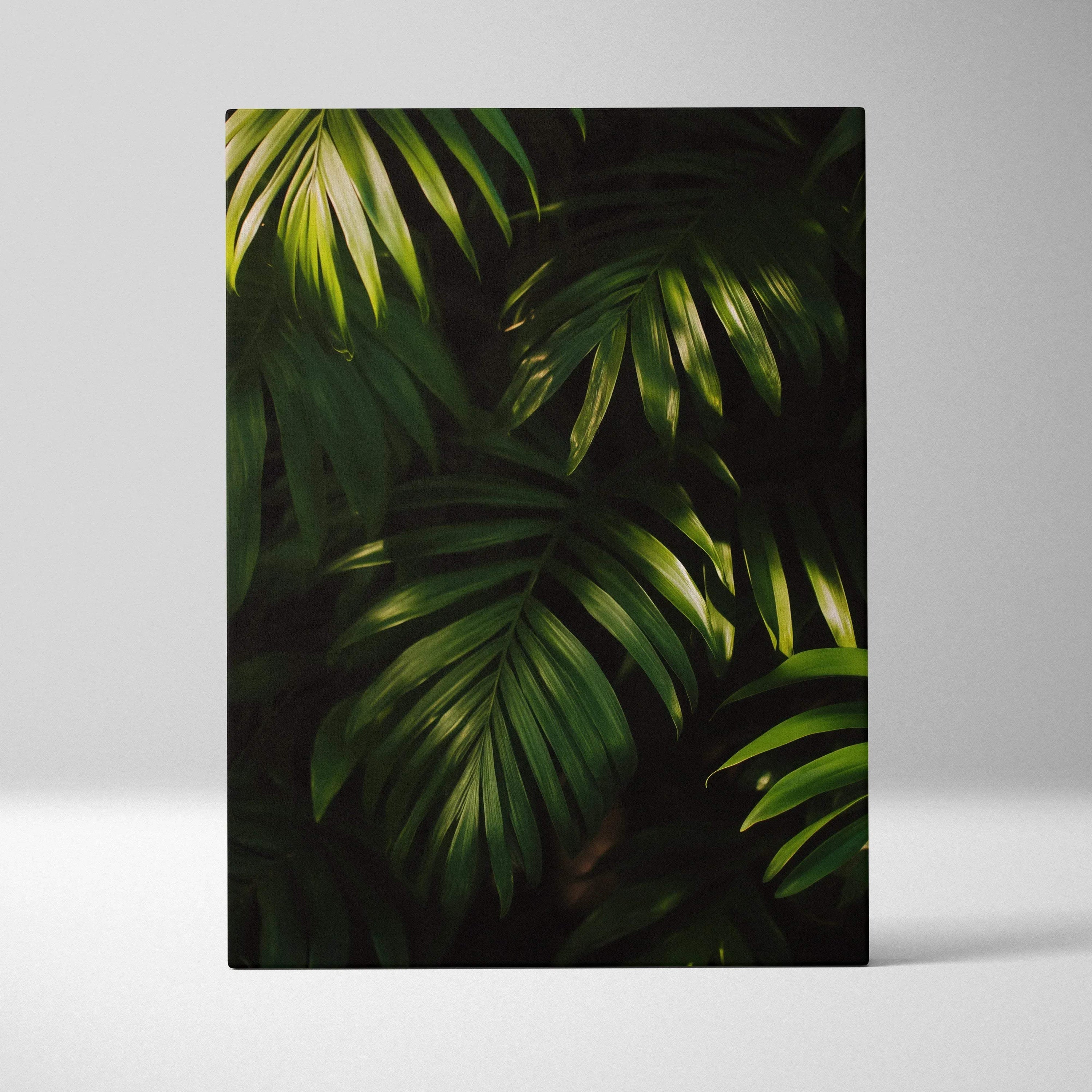 Vertical canvas wall art featuring dark green tropical leaves with detailed shadows for modern decor.