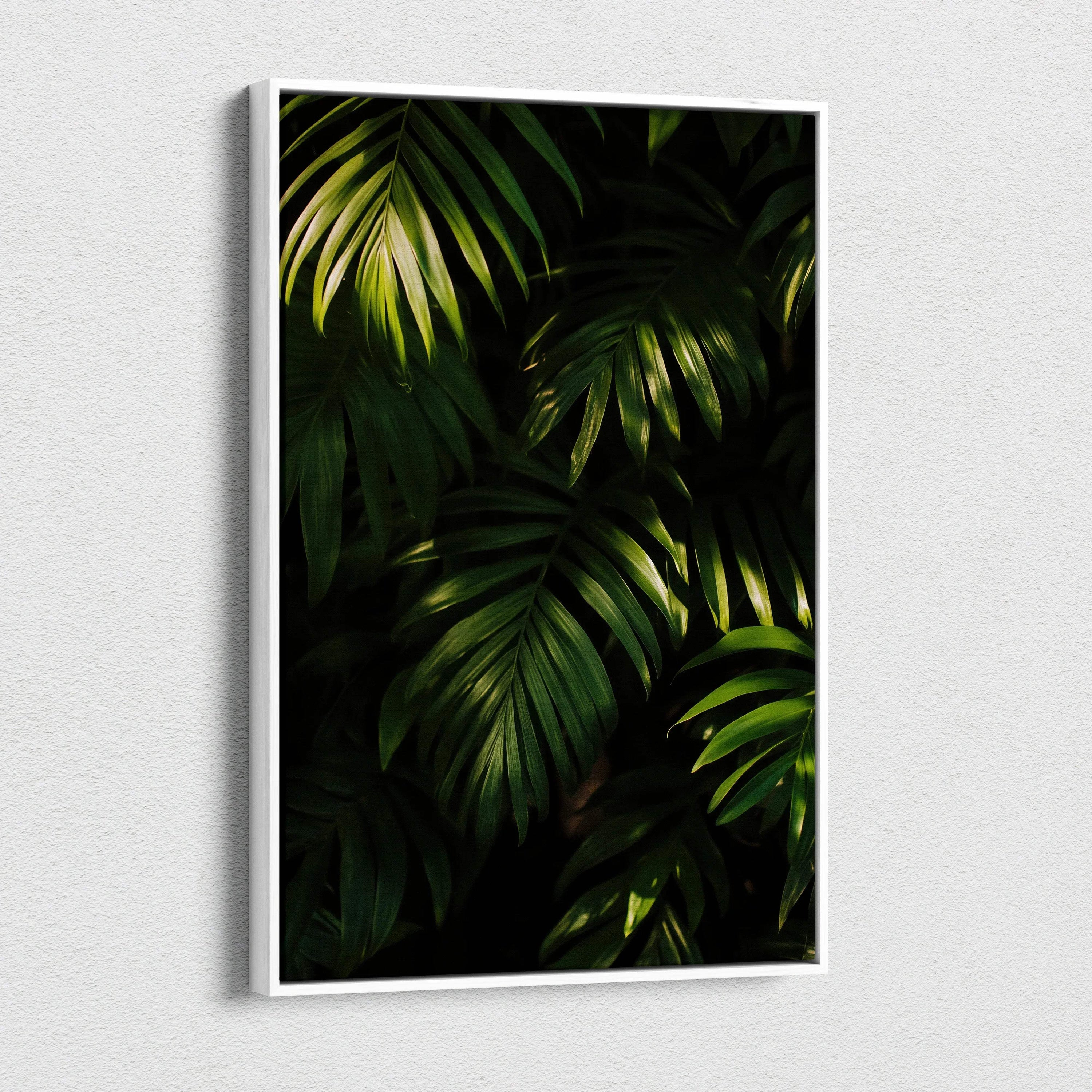 Canvas wall art featuring dark green tropical leaves with detailed shadows and highlights on a black background.