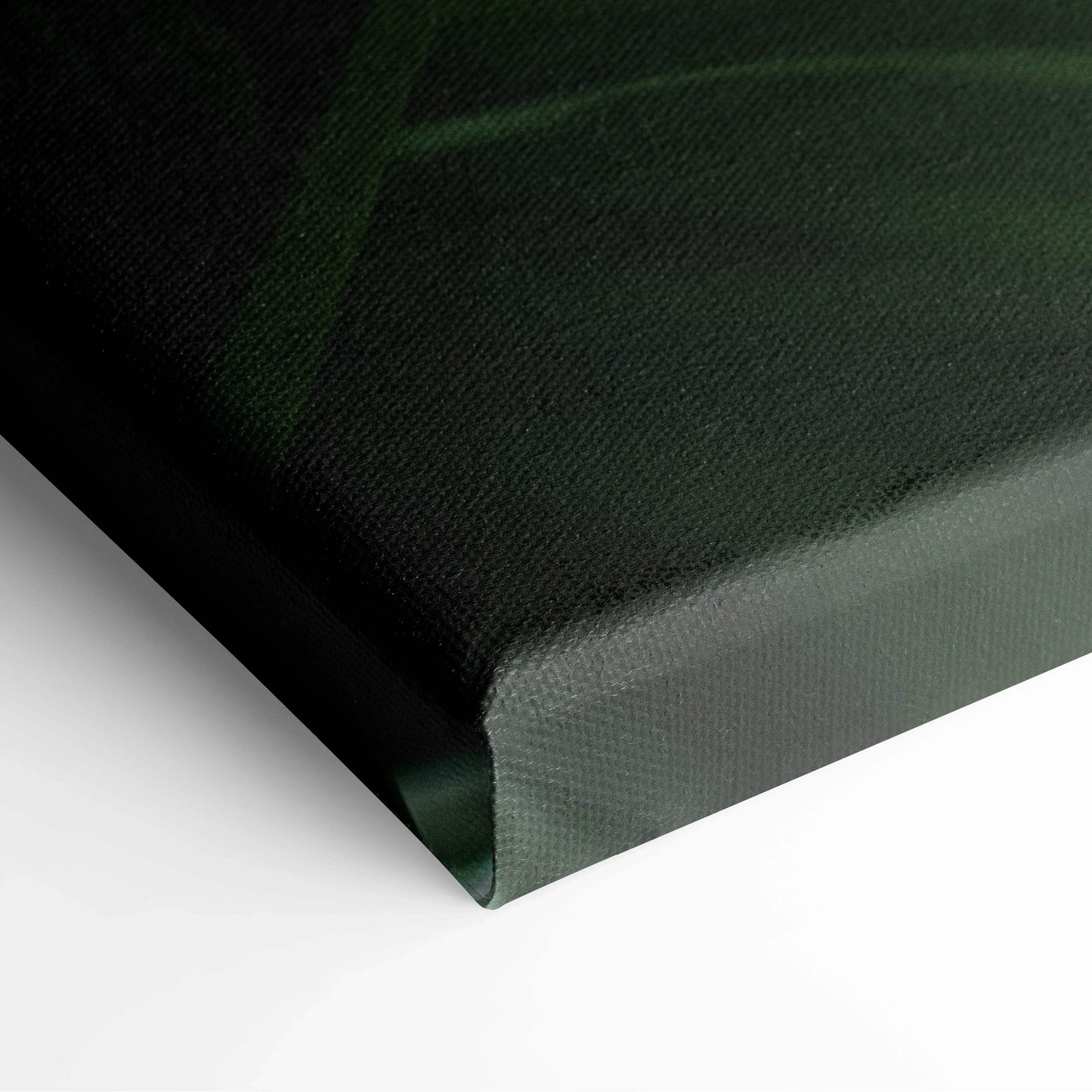 Close-up of canvas corner showing textured surface with dark green tropical leaf design and subtle sun flare effect in wall.