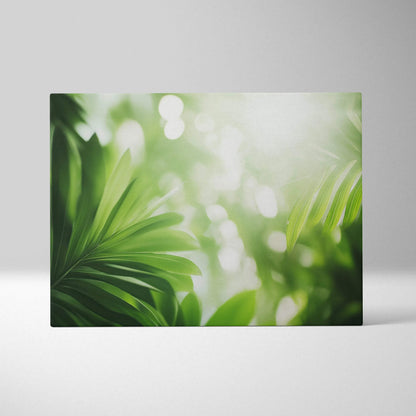 Canvas wall art featuring vibrant green tropical leaves with soft sun flare and blurred light effects.
