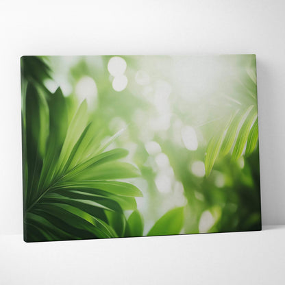 Green tropical leaves with sunlight flare on canvas wall art with soft blurred background.