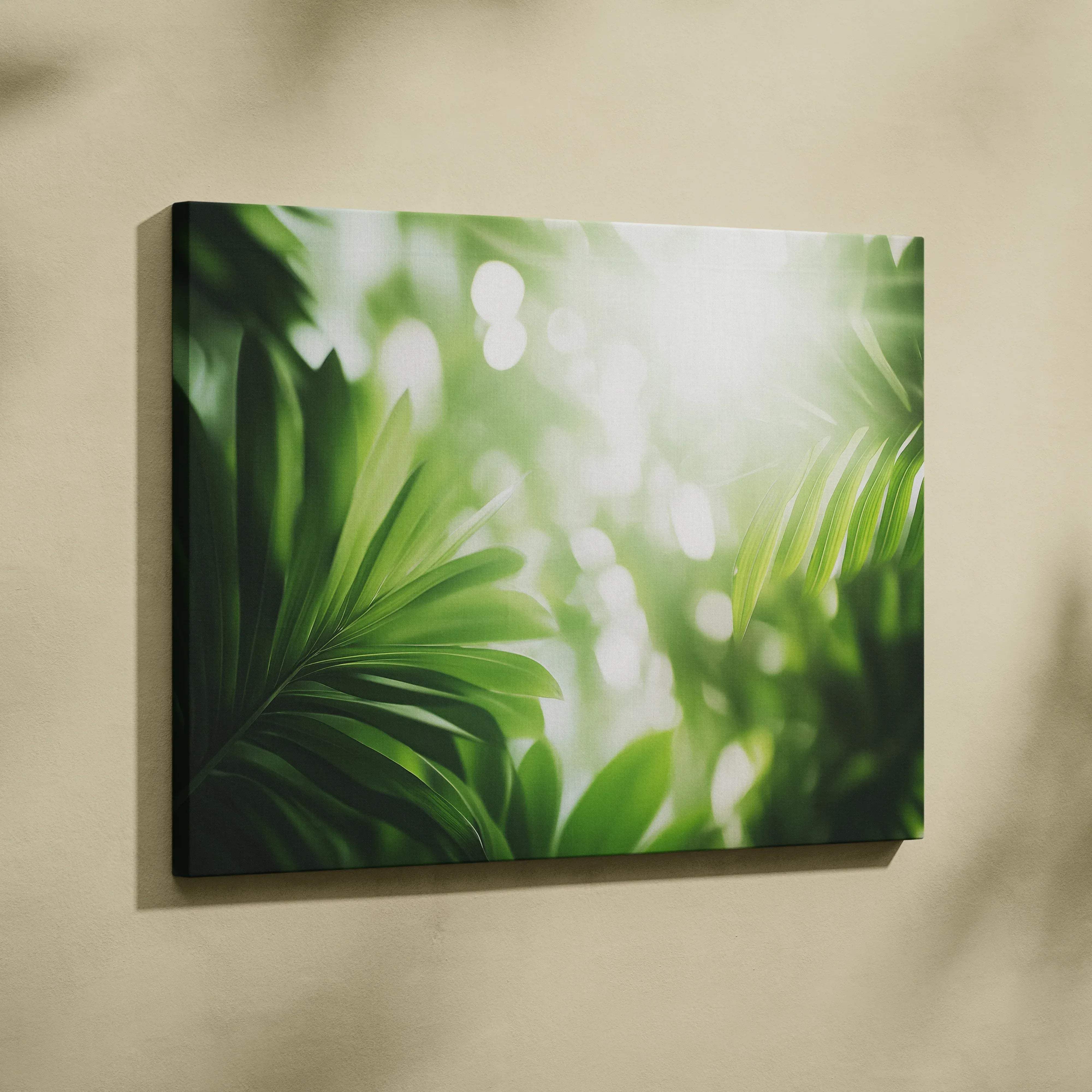 A rectangular canvas wall art featuring vibrant green tropical leaves with soft bokeh light effects and sun flare
